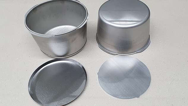 The three components before bonding: Pot, stainless steel base and aluminum blank.